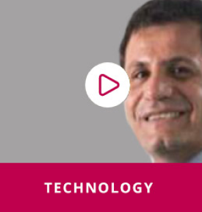 Graphic with a play button and a man smiling wearing a suit and tie. 