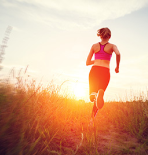Woman running in a field.