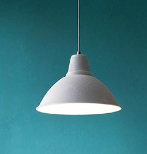 A lit lamp hanging in a room.